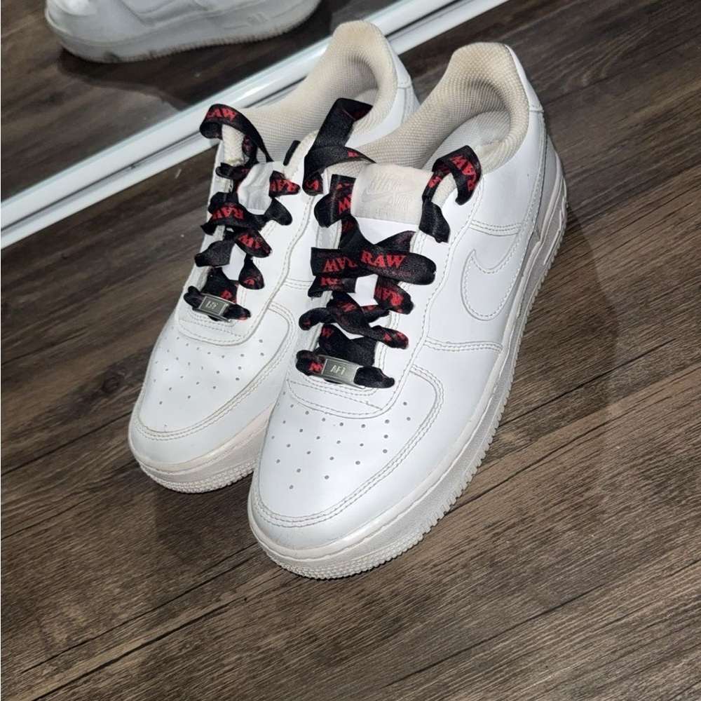 White Nike Air Force 1 Sneakers with Black & Red Raw Laces.